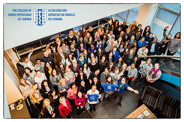 Group shot of CFPC employees in the foyer of the National office, celebrate the Great Place to Work certification